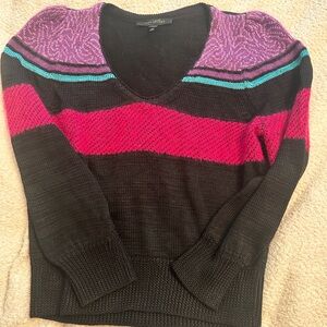 Marc Jacob’s Medium black striped wool v-neck sweater with a relaxed fit